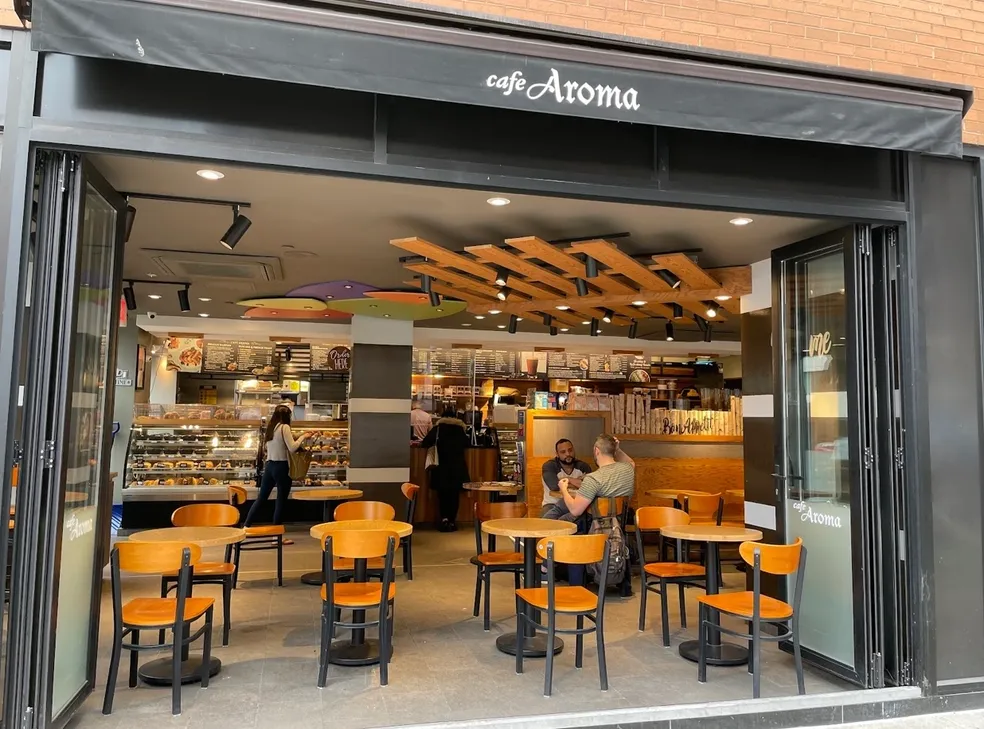 Cafe Aroma Interior showing cozy seating and warm atmosphere